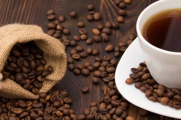 Fototapete Cafe Coffee cup with coffee bag on wooden table. coffeee beans   © alan