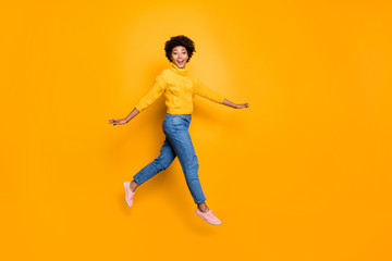 Fototapeta na wymiar Full length body size photo of cheerful charming cute nice glad girlfriend walking lightly jumping running wearing jeans denim pullover isolated vibrant color background