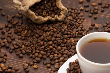 Coffee cup with coffee bag on wooden table. coffeee beans 