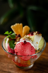 strawberry and pistachio gelato ice cream sundae dessert in bowl