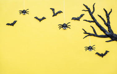 Halloween bats and spiders with tree on yellow background,Halloween Background with copy space..