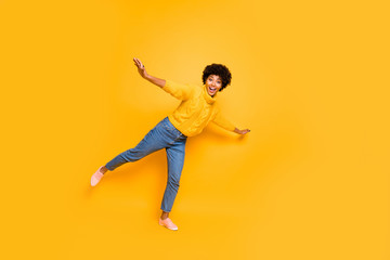 Fototapeta na wymiar Full length body size view of nice attractive cheerful funky childish comic hilarious wavy-haired girl having fun like plane flying isolated on bright vivid shine vibrant yellow color background