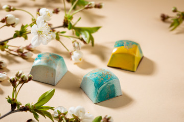 Sweet chocolate blue bonbons and cherry flowers