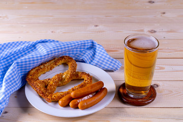 Oktoberfest beer with pretzel on wooden table with copy spce for text.