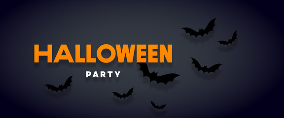Halloween holiday background with bats flying over orange background. Halloween concept. Flat lay
