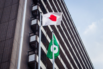Japanese flag and Kumamoto city flag which are attached to flag poles. Kumamoto city flag was...