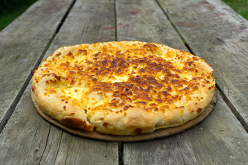 Traditional Georgian food khachapuri on the wooden table