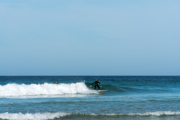 teenager surfing on the west coast of Brittany in France at Toulinguet Beach near Camaret-Sur-Mer