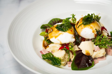 Eggs benedict with Thai style basil sauce  top on bread and ham fusion food breakfast 