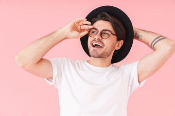 Image of handsome man wearing eyeglasses and hat looking aside