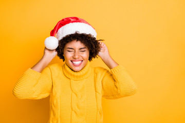 I wish all my dreams come true. Photo of cute glad excited optimistic girl trying to wear magic hat on head making wishes wearing vivid color pullover isolated bright background