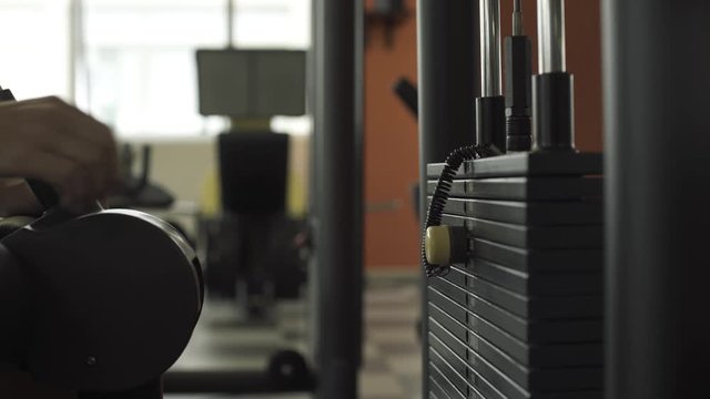 Woman selecting weight on a exercise machine