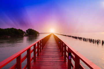 Fototapeta na wymiar Long Red Bridge sunlight sky tree at beach sea,Red bridge Samut Sakhon Thailand