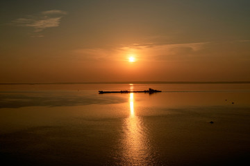 Dawn early in morning over wide long Volga river