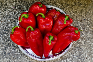 A few red, ripe, raw peppers, paprika or Capsicum with green stem prepared for canning, Sofia, Bulgaria 