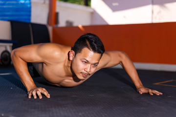 Fototapeta na wymiar Man try to push up exercise for chest workout at home fitness.