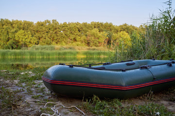 rubber green boat parked on the ground and grass