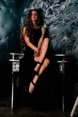 young gorgeous lady posing in lace dress, over black. space for copy