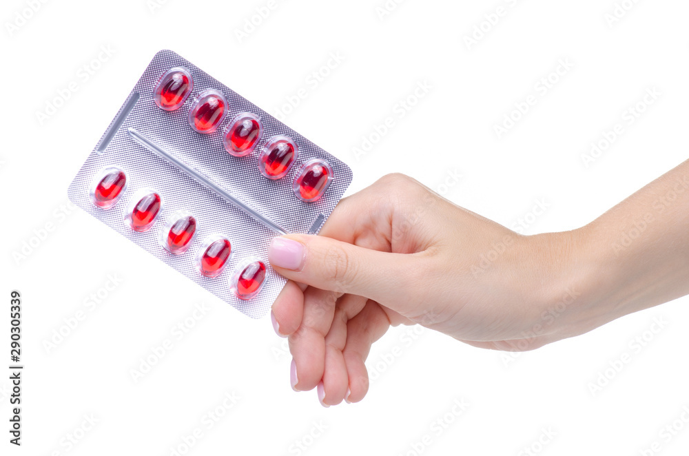 Sticker Blister red pills in hand medicine pharmacy on white background isolation