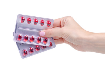 Blister red pills in hand medicine pharmacy on white background isolation