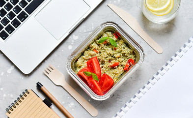 Food delivery. Lunch box with a diet lunch or breakfast or dinner on grey office table. takeaway lunch at the office. Top view . takeout healthy lunch. selective focus