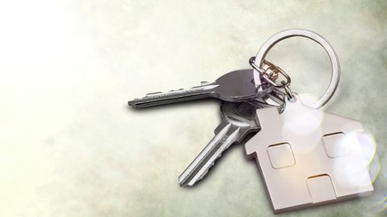 Silver Home key with badge on wooden table