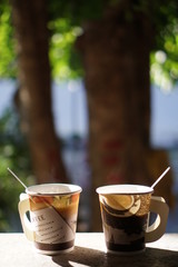 cup of coffee on wooden table in the garden
