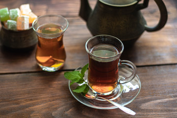 Arabic, oriental tea with lemon. Warms on cold evenings, cools in the hot summer. Heals colds. Nearby lies a fresh root and lime green.