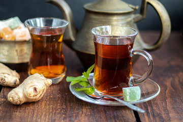 Arabic, oriental tea with lemon. Warms on cold evenings, cools in the hot summer. Heals colds. Nearby lies a fresh root and lime green.