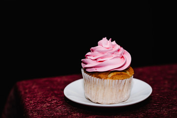 Delicious sweet muffin, cupcake or cake on the plate. Festive sweet table, candy bar. The concept holiday, birthday celebration.