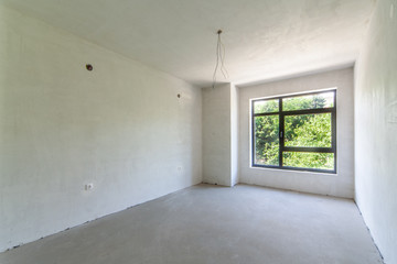 Empty unfinished room. Unfinished building interior, white room.Repairs in the apartment.