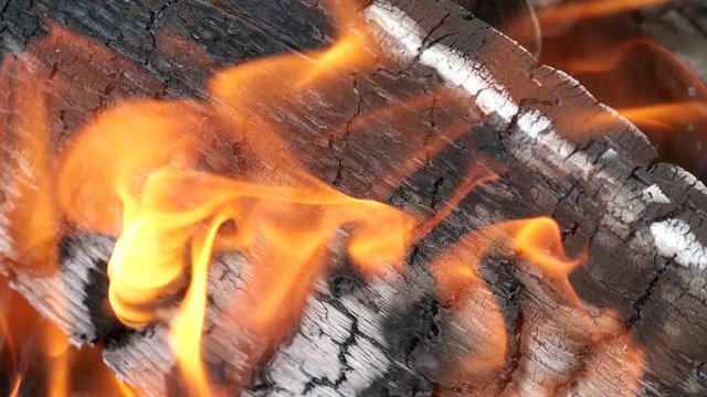 Burning a bright flame wood closeup.