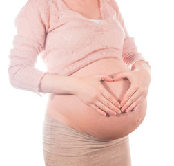 Pregnant woman profile holding hands protectively over belly