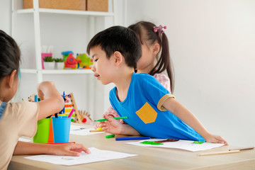 Obraz na płótnie Canvas Children playing with friend in playroom at school