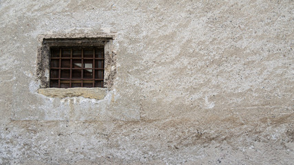 medieval wall with window and rusted railing