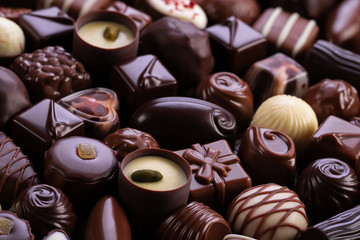 Chocolate candies background, sweet food with various fillings.