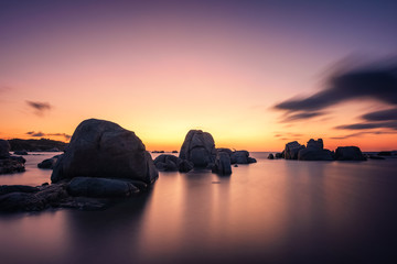 Fototapeta na wymiar Sunrise over boulders at Cavallo Island in Corsica
