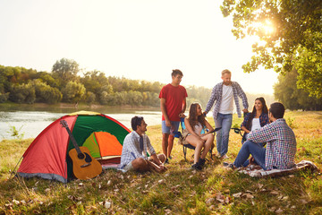 A group of friends have a picnic in a forest in autumn.