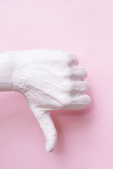 Beautiful hand of a woman in pink paint showing guester dislike