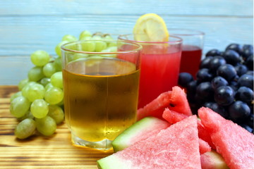 three types of juice in glasses, watermelon, grapes, green and black