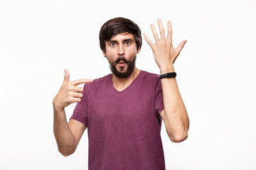 Excited brunet bearded man with moustaches pointing at smart watches. Using modern technologies in...