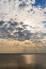 Sun light through the sky blast over the sea
