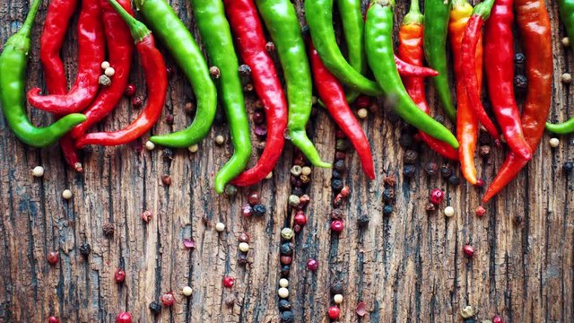 Arrangement of chili peppers on a table, top view.