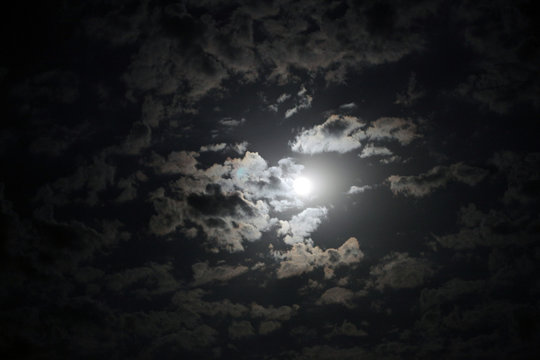 Black night sky with moon and clouds. Nature background.