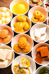 Rangoli of Assorted Indian sweets/mithai in bowl for Diwali or any other festivals, selective focus