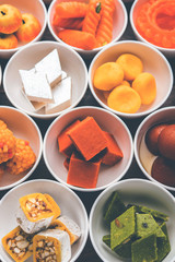 Rangoli of Assorted Indian sweets/mithai in bowl for Diwali or any other festivals, selective focus