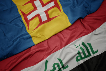 waving colorful flag of iraq and national flag of madeira.