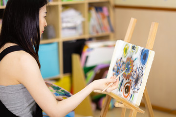 Artist painting oil painting on an easel