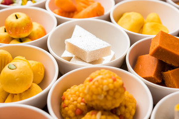 Rangoli of Assorted Indian sweets/mithai in bowl for Diwali or any other festivals, selective focus