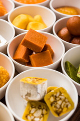 Rangoli of Assorted Indian sweets/mithai in bowl for Diwali or any other festivals, selective focus